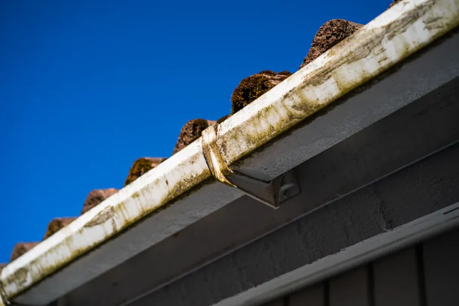 Aged gutter with algae streaking and an open lap joint on an older home in Mint Hill NC